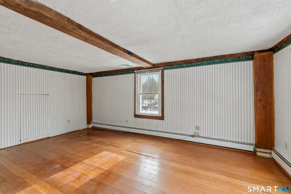 an empty room with windows closet and fireplace