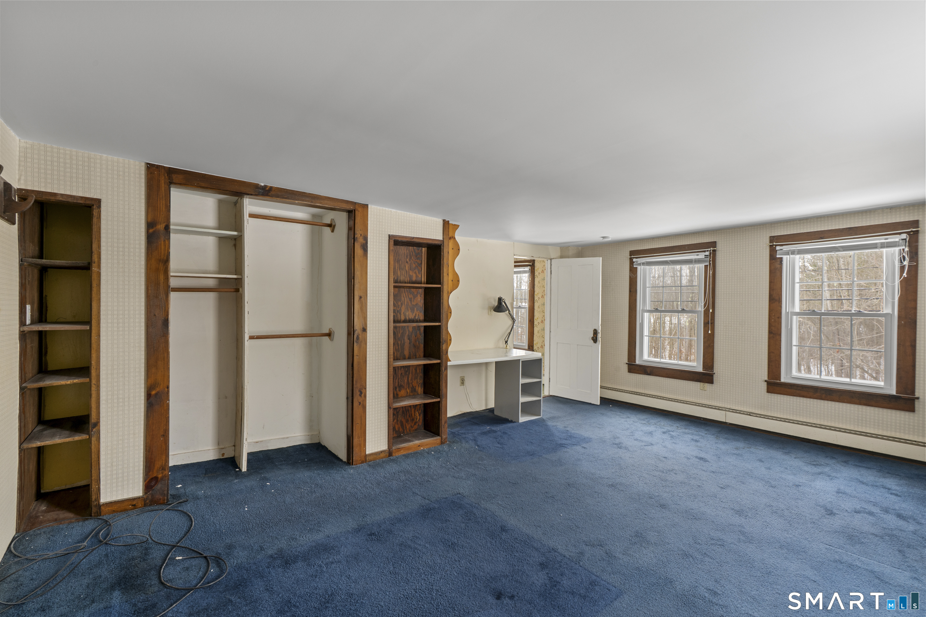 392 Boston Neck Road Suffield, CT 06078 - Photo 29 of 35 an empty room with windows closet and fireplace