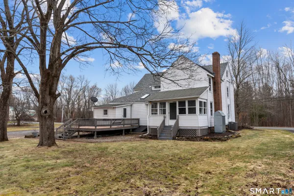 a backyard of a house with fire pit and trees