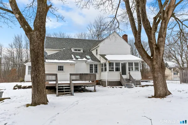 an aerial view of a house with a mountain