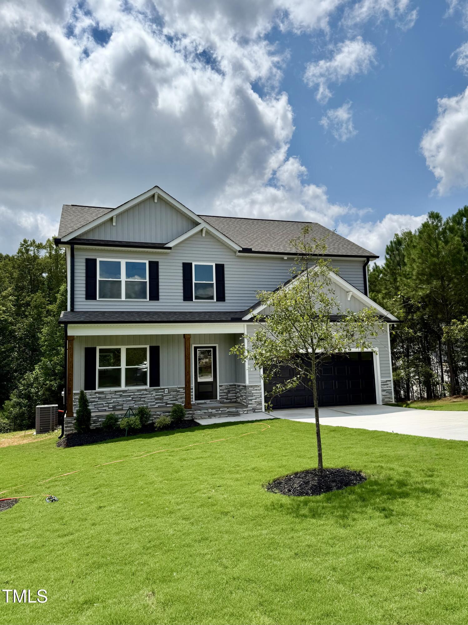 50 Moonraker Drive Spring Hope, NC 27882 - Photo 2 of 37 a front view of a house with a garden