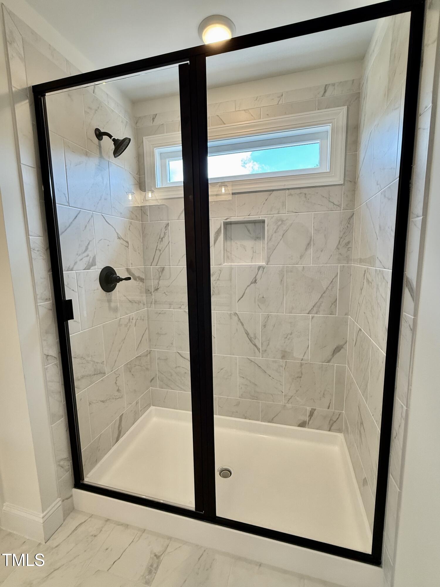 50 Moonraker Drive Spring Hope, NC 27882 - Photo 22 of 37 a bathroom with a glass shower door and a window