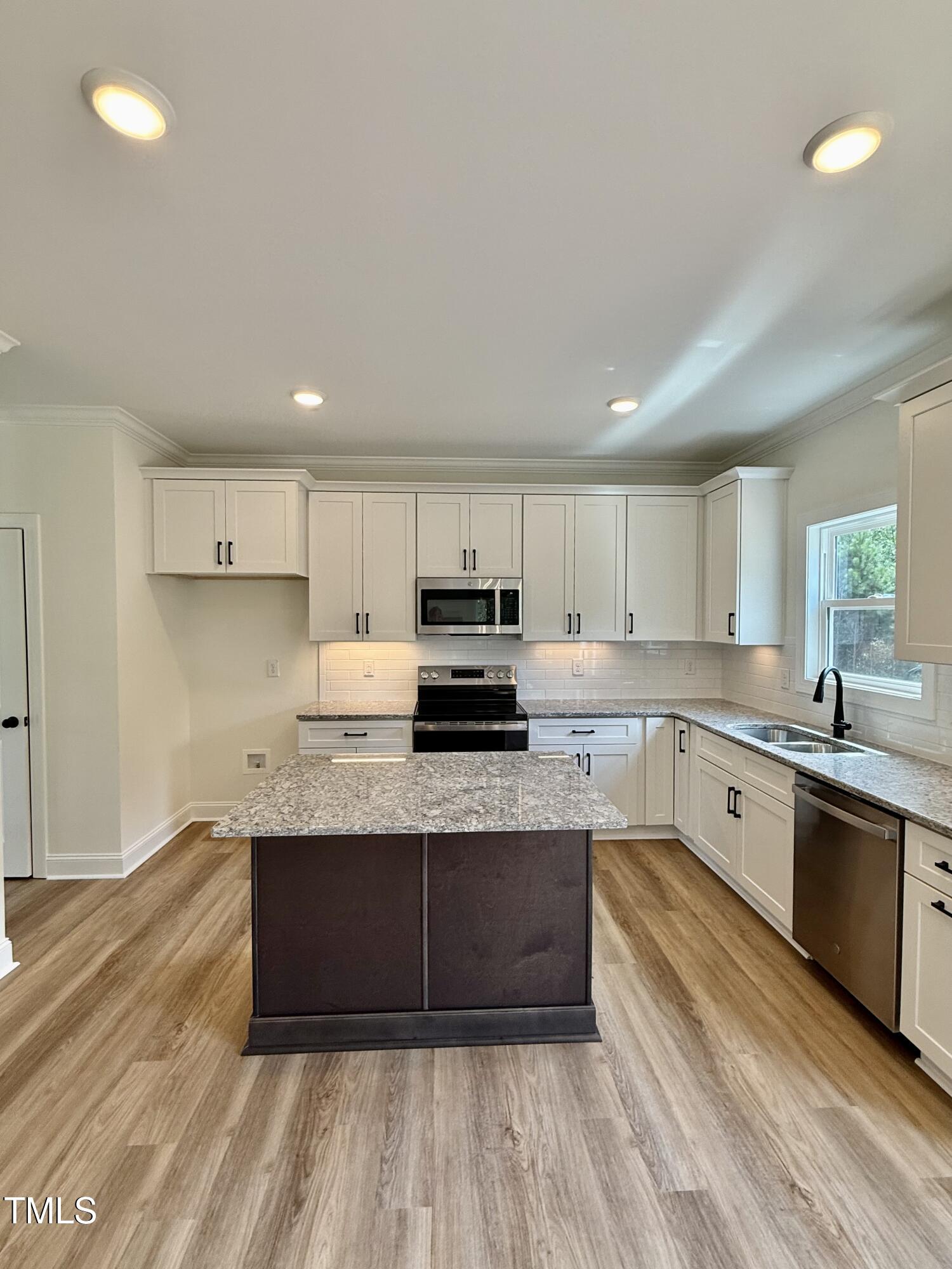 50 Moonraker Drive Spring Hope, NC 27882 - Photo 7 of 37 a large kitchen with stainless steel appliances granite countertop a stove a sink dishwasher and a oven with white cabinets