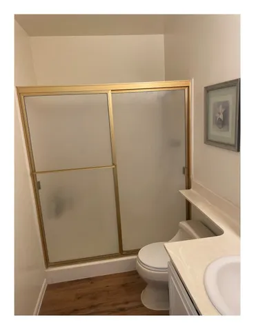 a bathroom with a toilet and a shower