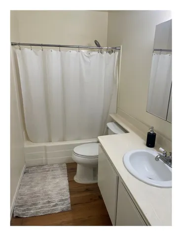 a bathroom with a sink toilet and a mirror