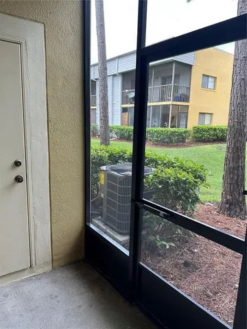 a view of a porch with a floor to ceiling window and a room