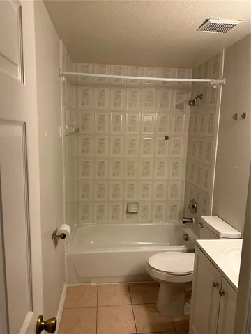 a bathroom with a toilet a sink and shower