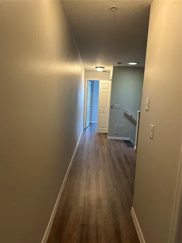 a view of hallway with wooden floor