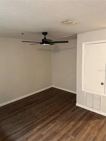 a view of a room with wooden floor