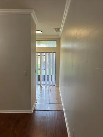 a view of a hallway with wooden floor