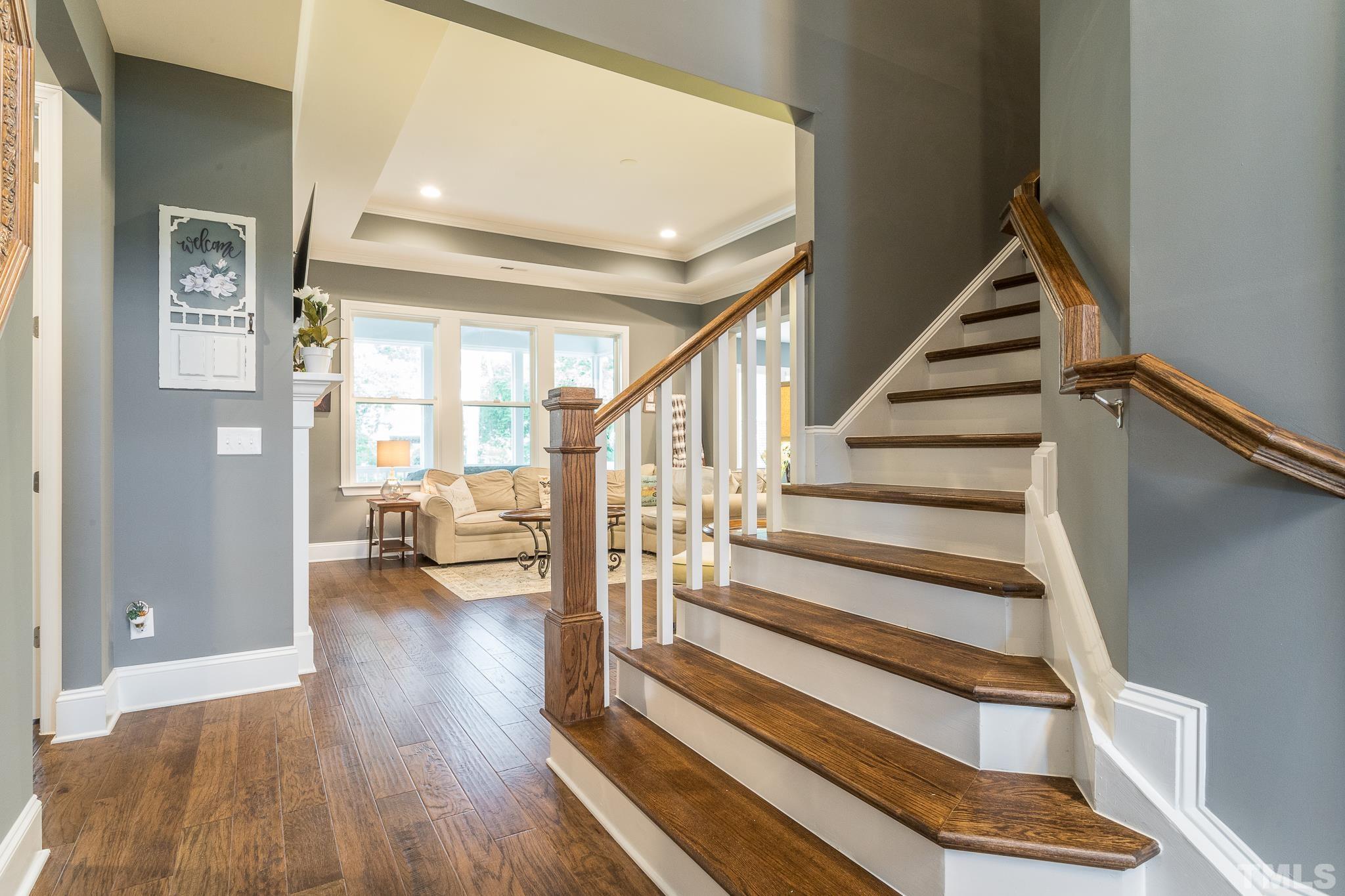 5281 Aleppo Lane Raleigh, NC 27613 - Photo 12 of 57 a view of staircase with wooden floor and a rug