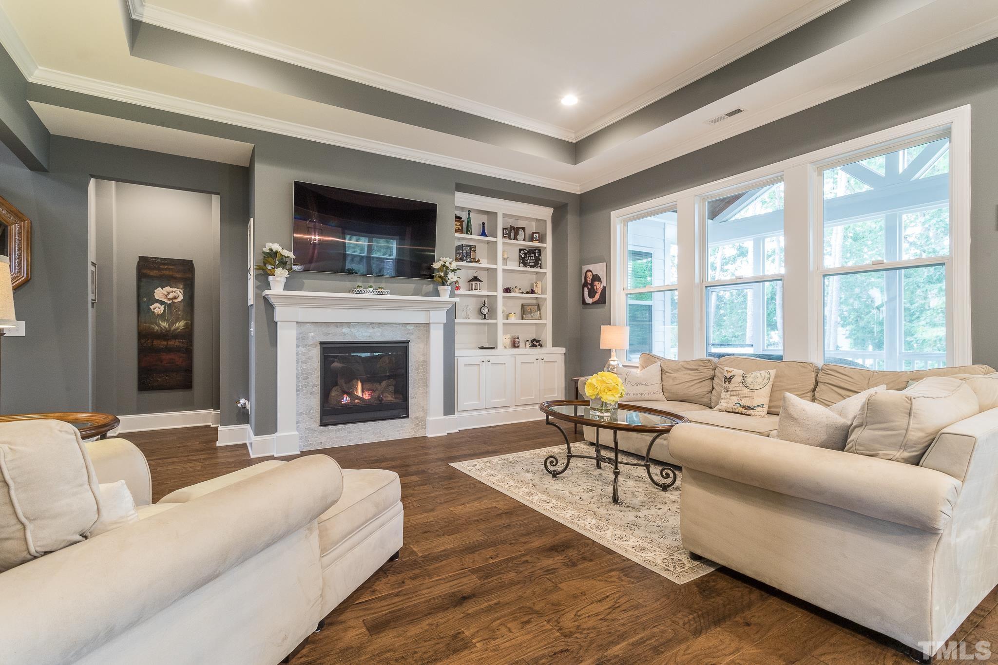 5281 Aleppo Lane Raleigh, NC 27613 - Photo 2 of 57 a living room with furniture large window and a fireplace