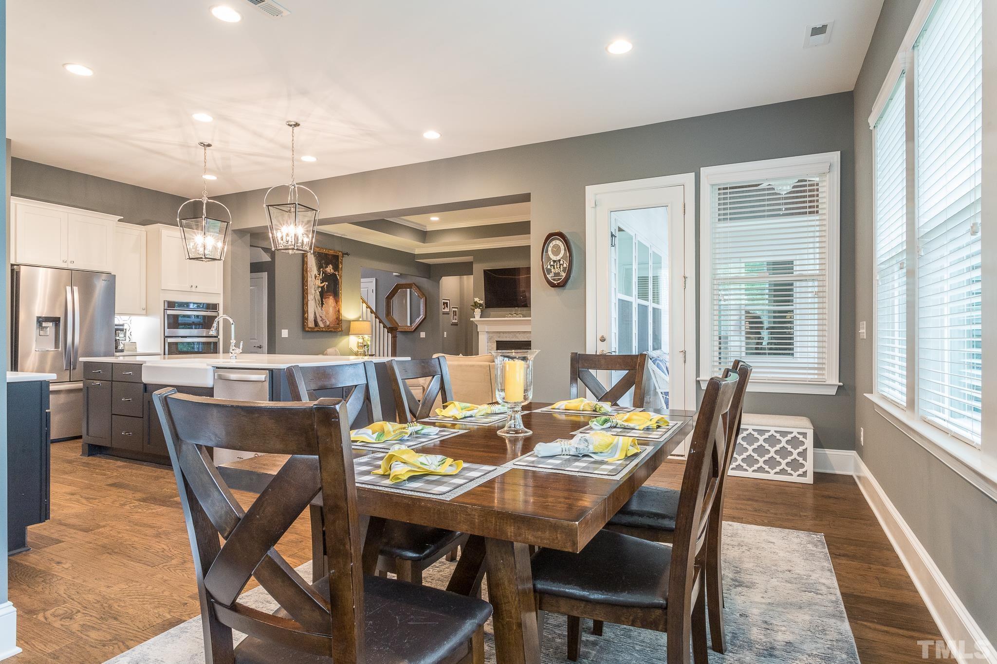 5281 Aleppo Lane Raleigh, NC 27613 - Photo 25 of 57 a view of a dining room with furniture window and wooden floor
