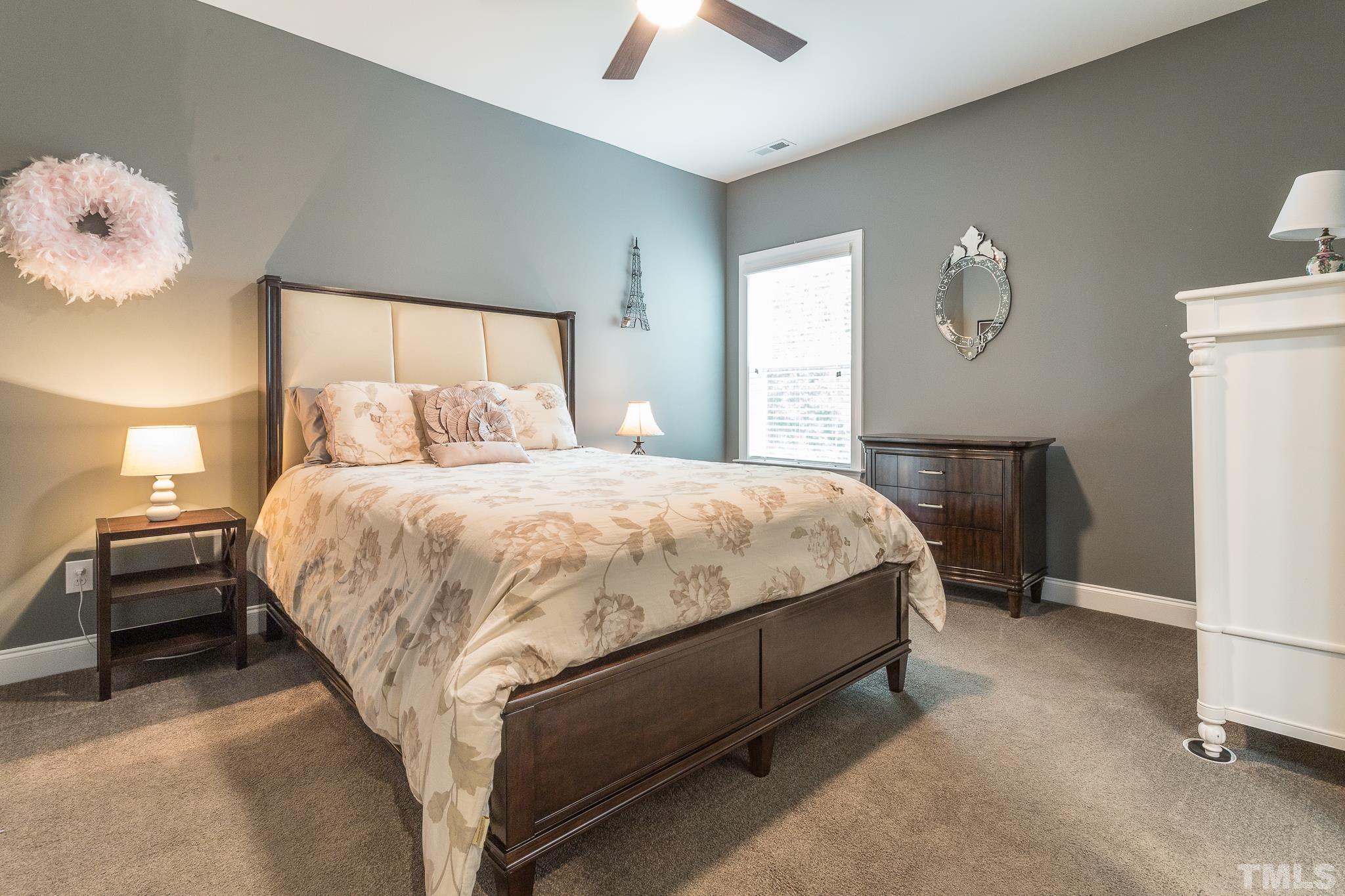 5281 Aleppo Lane Raleigh, NC 27613 - Photo 31 of 57 a bedroom with a bed and a chandelier
