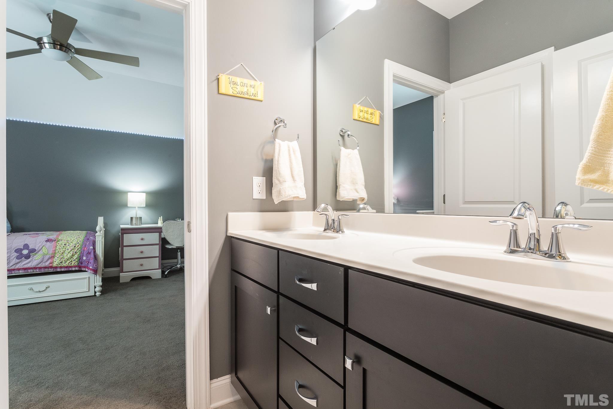 5281 Aleppo Lane Raleigh, NC 27613 - Photo 33 of 57 a en suite bathroom with a double vanity sink and a mirror