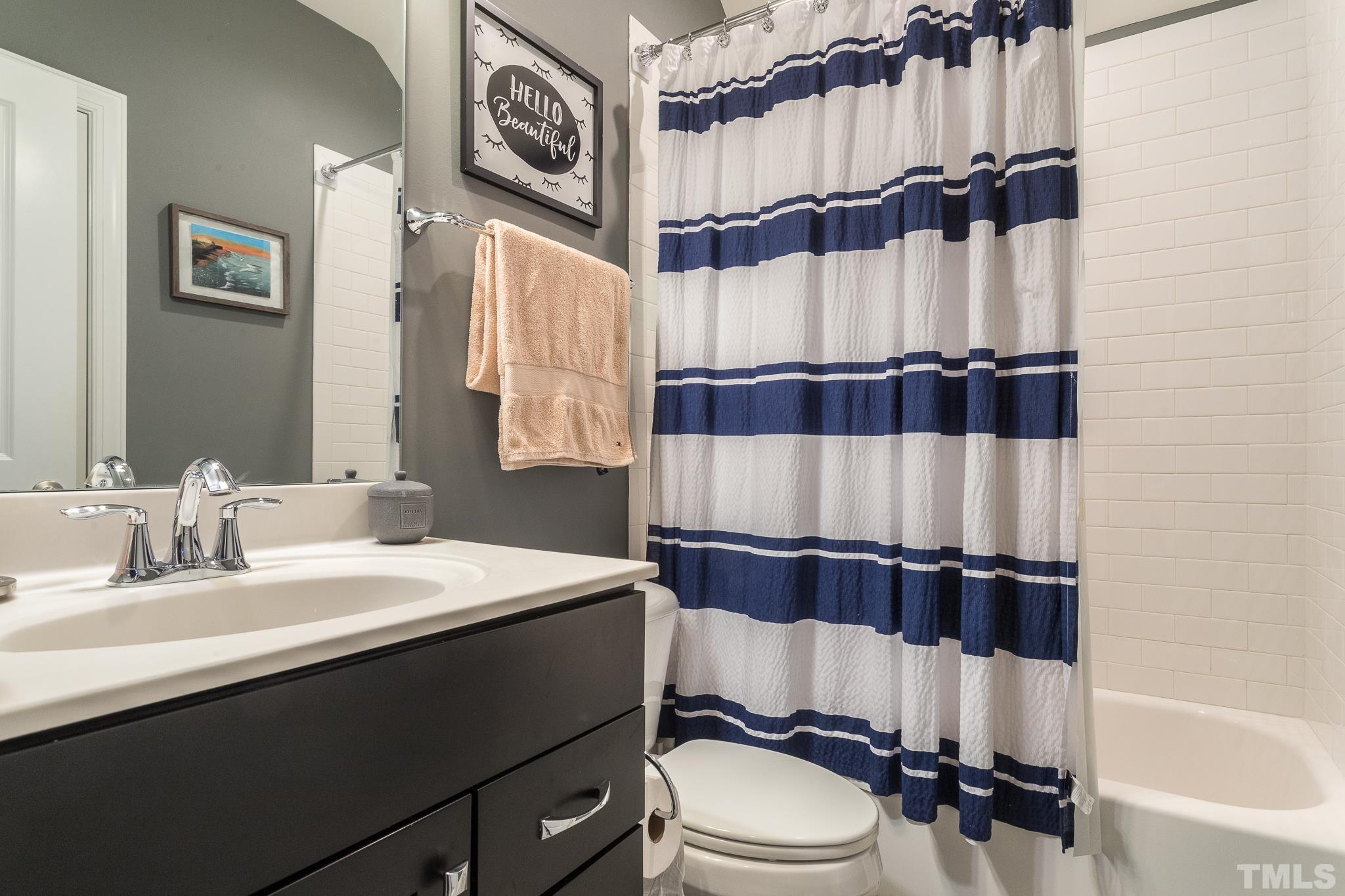 5281 Aleppo Lane Raleigh, NC 27613 - Photo 35 of 57 a bathroom with a sink a toilet and a shower