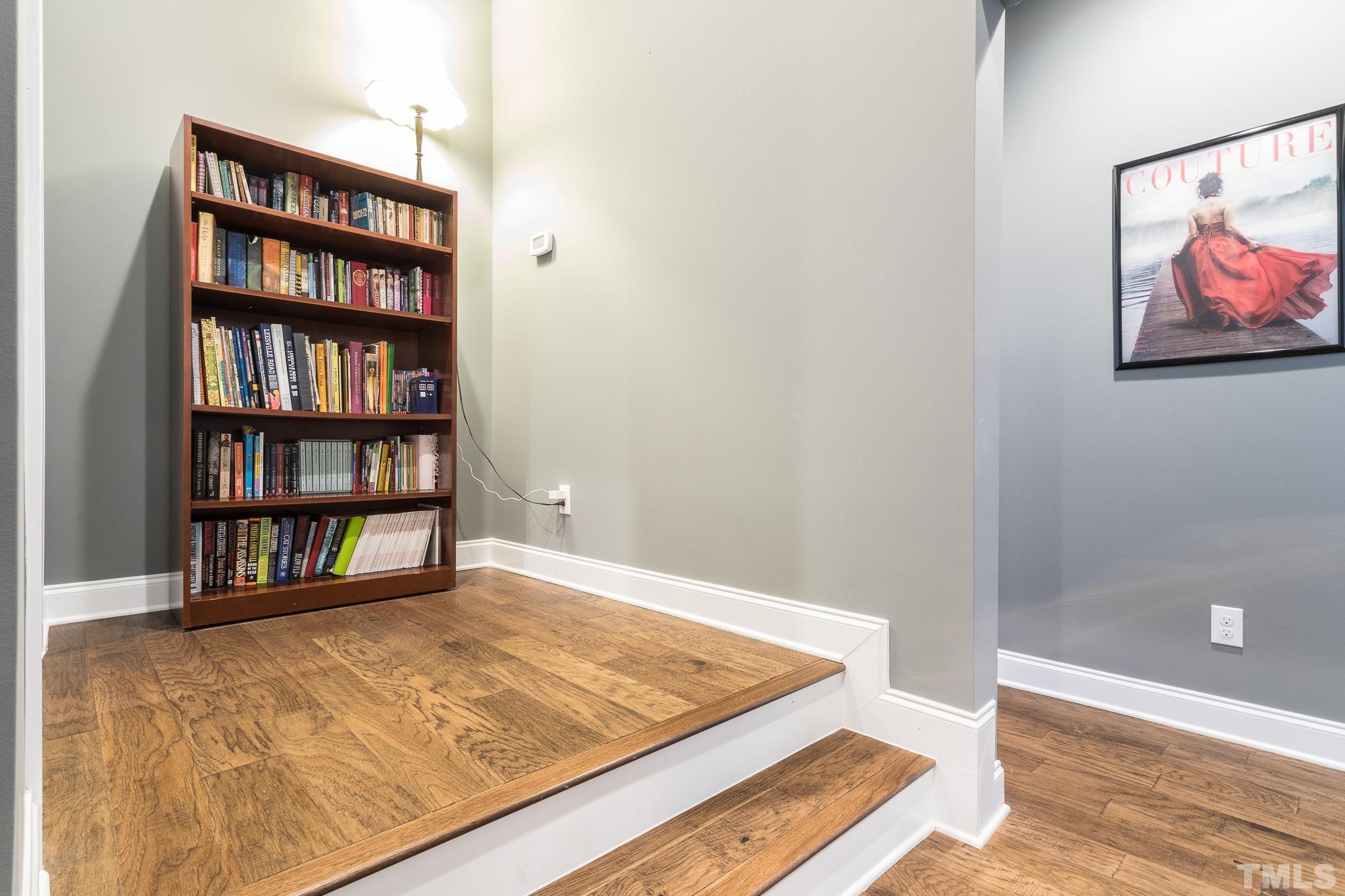 5281 Aleppo Lane Raleigh, NC 27613 - Photo 36 of 57 a view of room with bookshelf and wooden floor