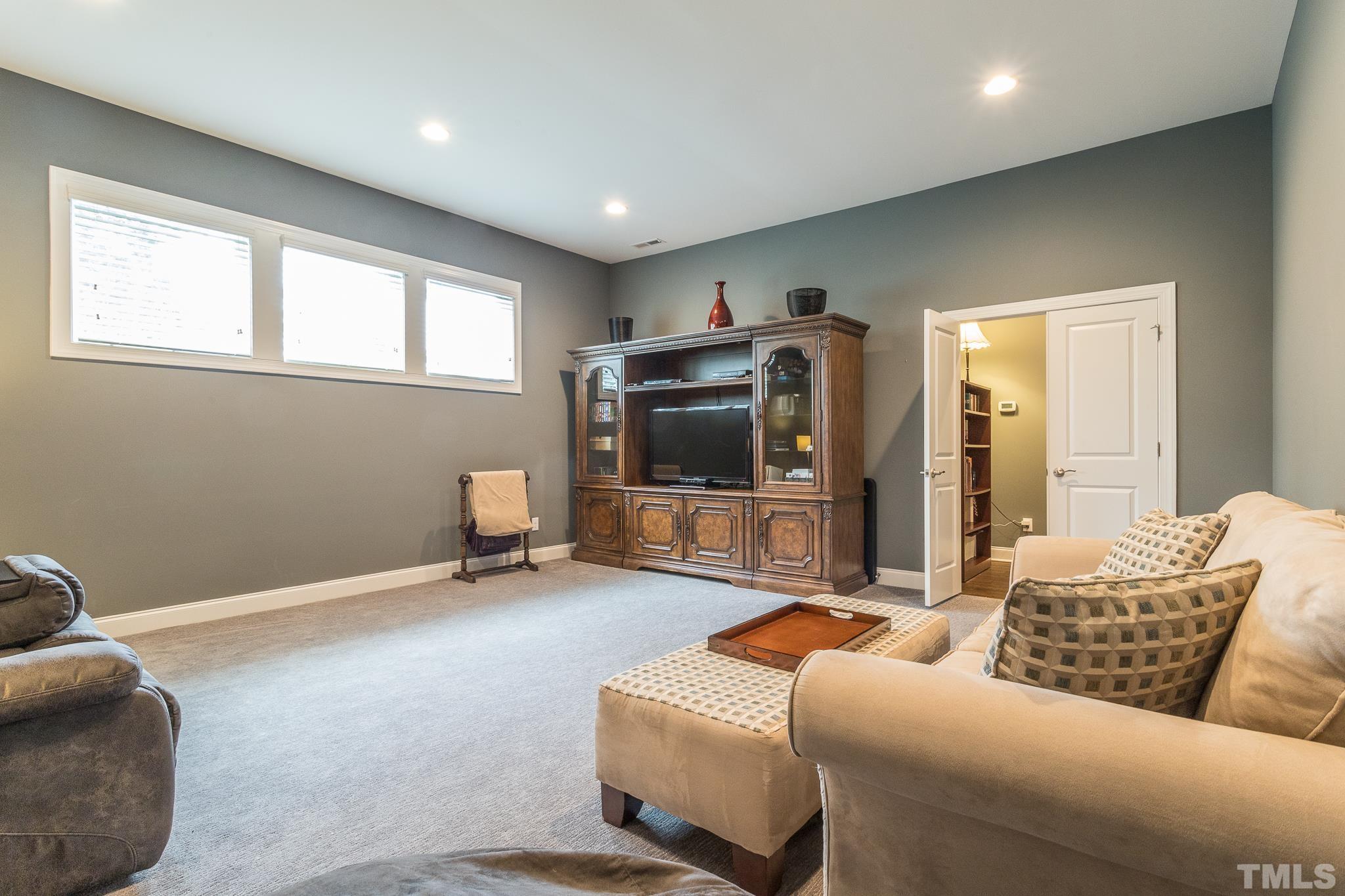 5281 Aleppo Lane Raleigh, NC 27613 - Photo 37 of 57 a living room with furniture and a flat screen tv