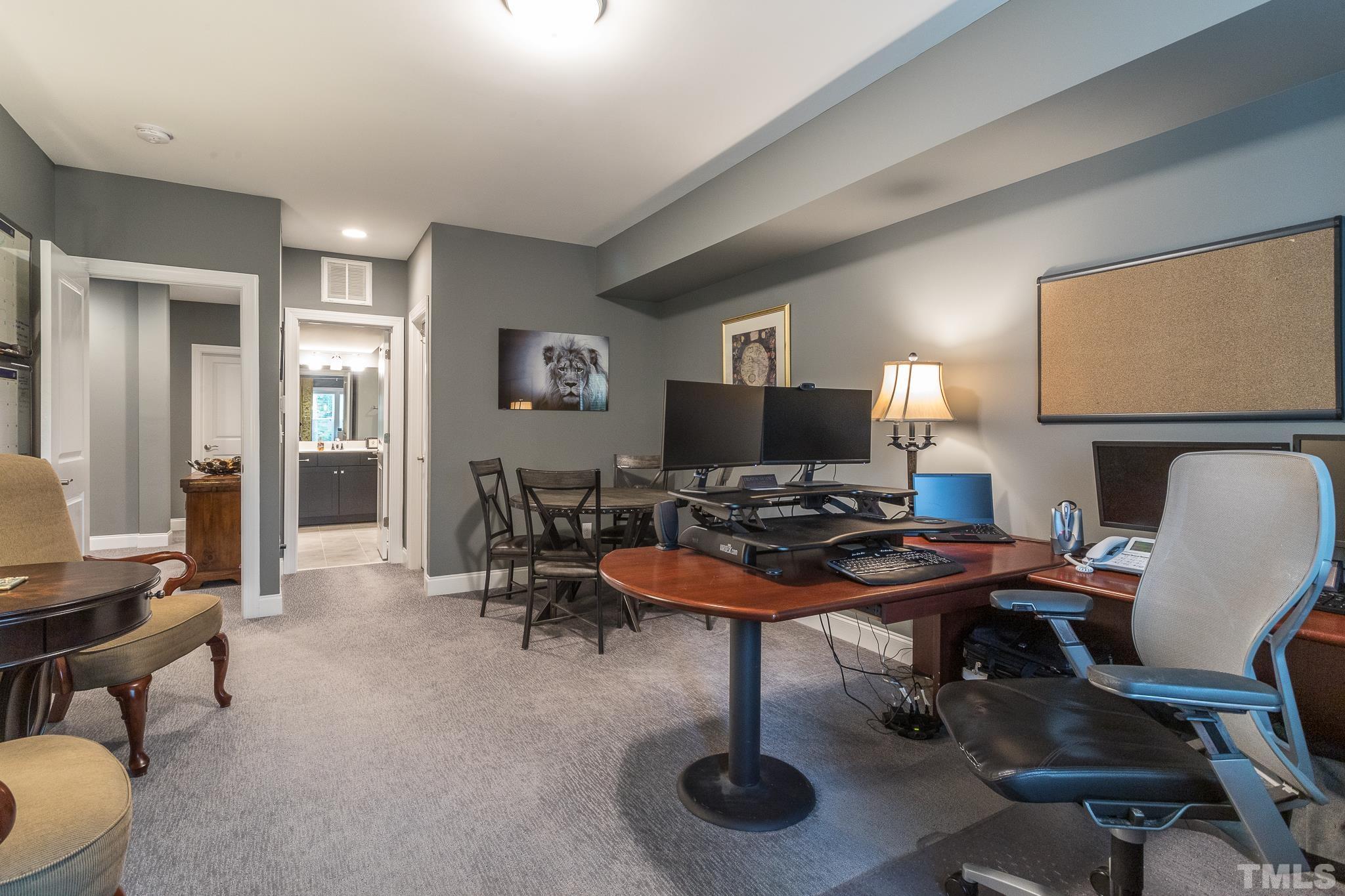 5281 Aleppo Lane Raleigh, NC 27613 - Photo 43 of 57 a view of a workspace with furniture and a potted plant