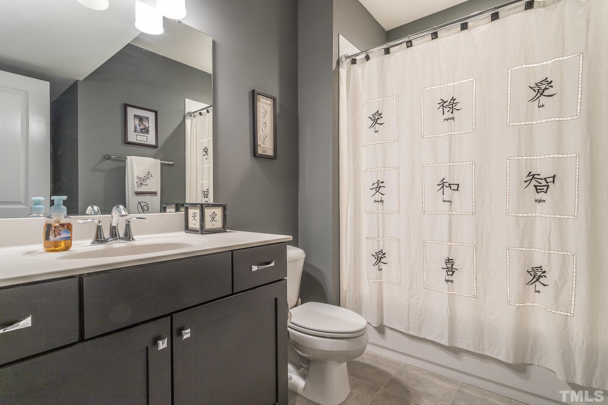 5281 Aleppo Lane Raleigh, NC 27613 - Photo 44 of 57 a bathroom with a sink toilet a mirror and shower