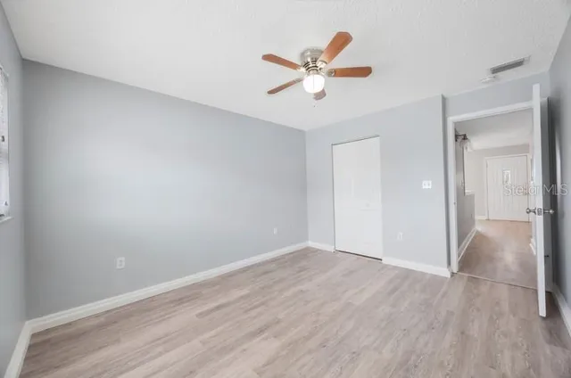 a view of a livingroom with a hardwood floor and a ceiling fan