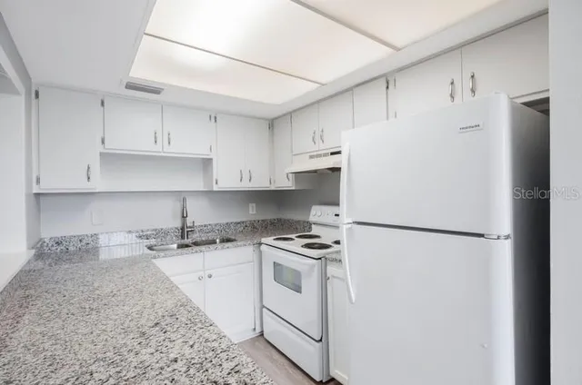 a white refrigerator freezer sitting in a kitchen
