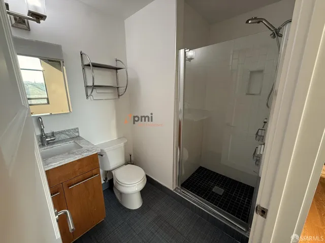 a bathroom with a toilet and a shower