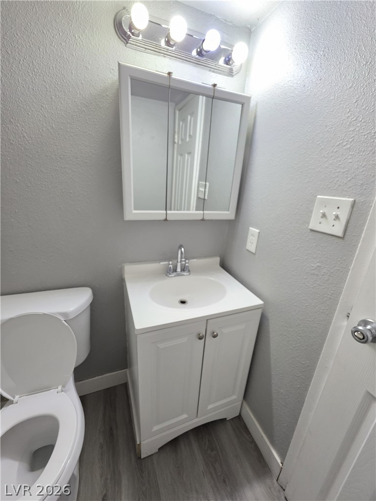 1089 East Desert Inn Road, Unit 3 Las Vegas, NV 89109 - Photo 8 of 15 A well-lit powder room offers practicality and a modern vanity.