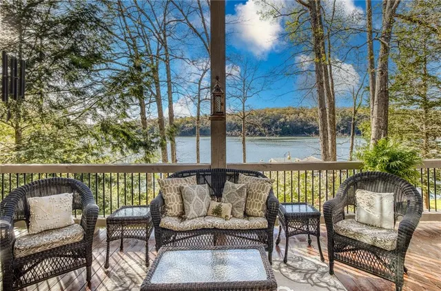an aerial view of a house with swimming pool and lake view