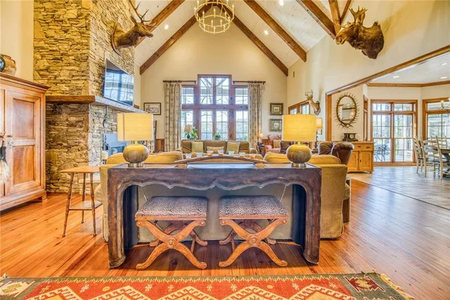 a living room with furniture large window and a fireplace