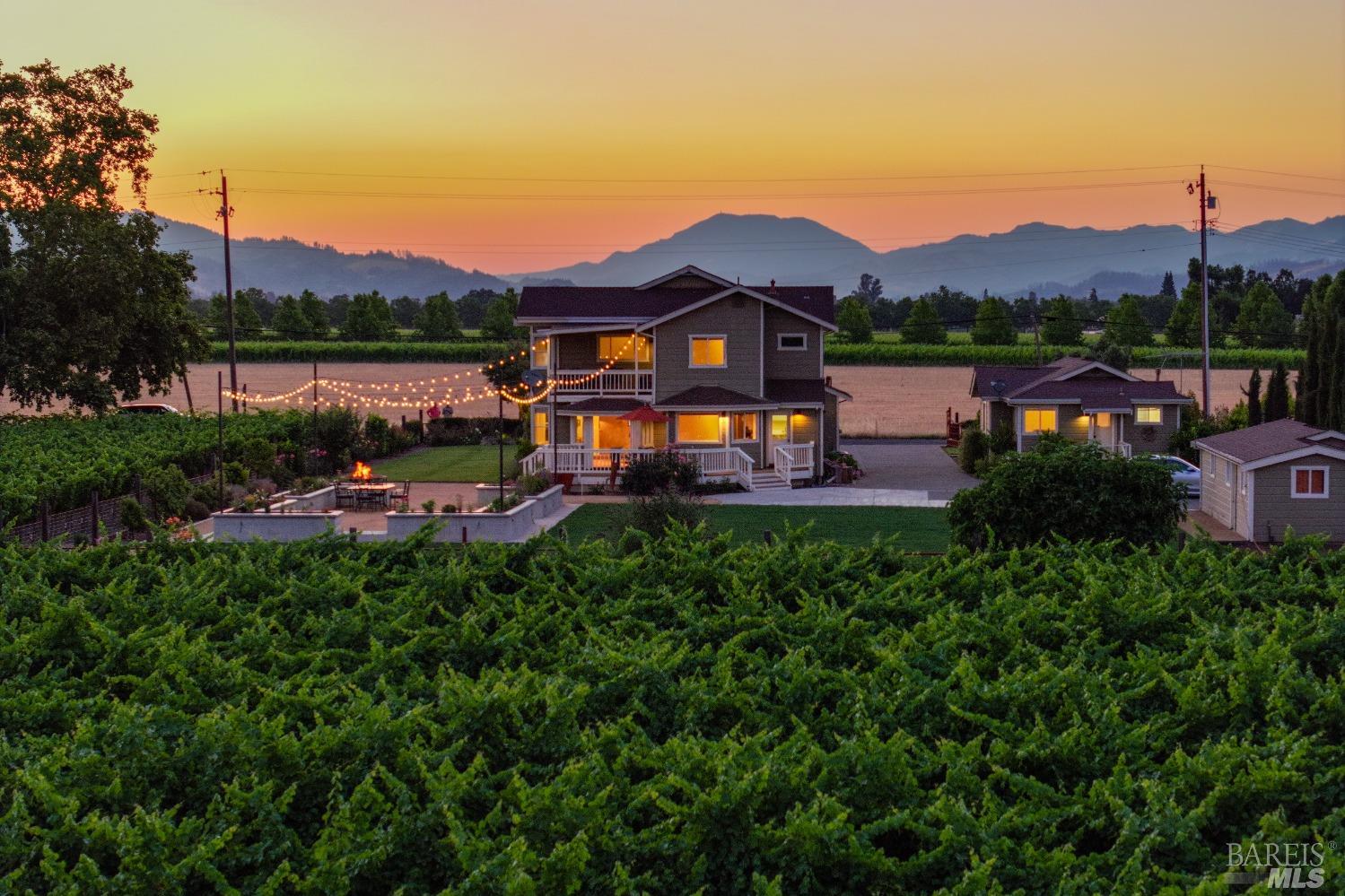 a view of a house with a garden and a lake view
