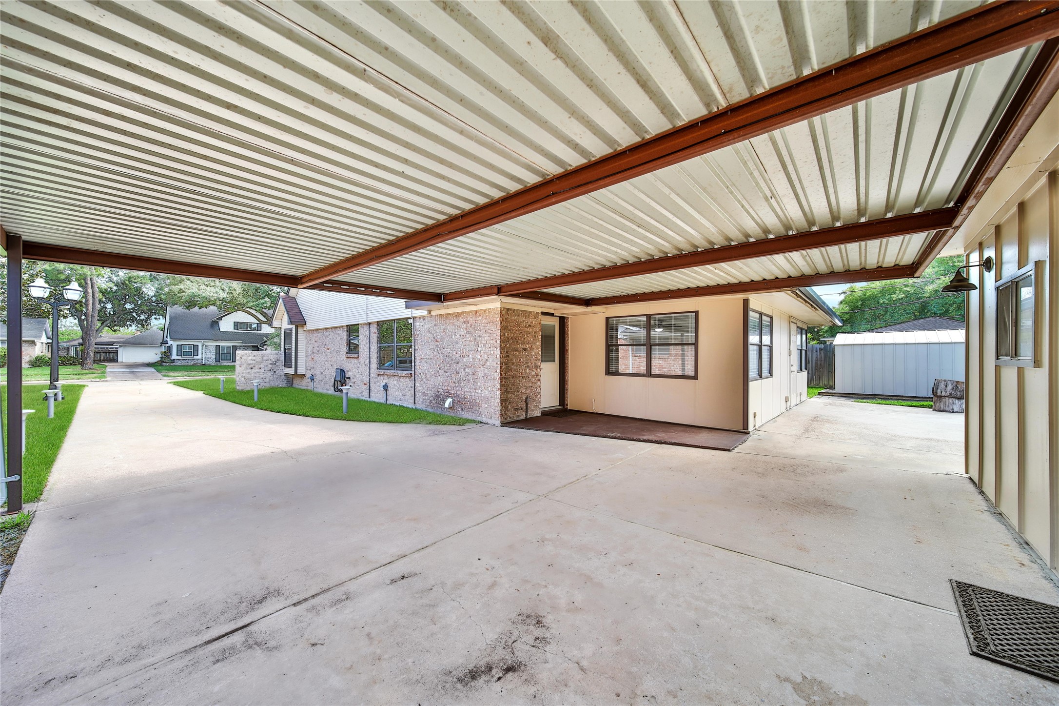 9411 Roos Road Houston, TX 77036 - Photo 38 of 41 a view of a patio with a table and chairs and floor to ceiling window
