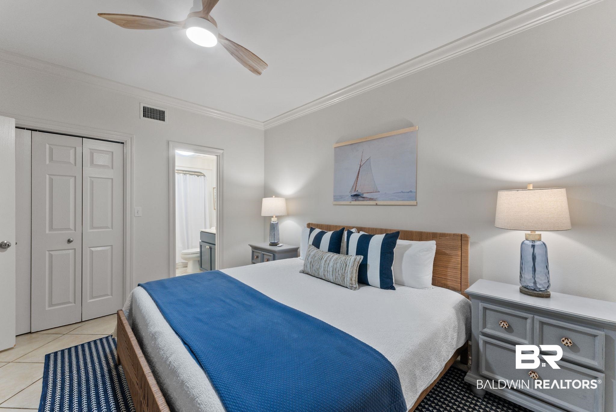 27580 Canal Road, Unit 1233 Orange Beach, AL 36561 - Photo 7 of 79 Bedroom featuring ornamental molding, a closet, a ceiling fan, ensuite bath, and light tile patterned floors