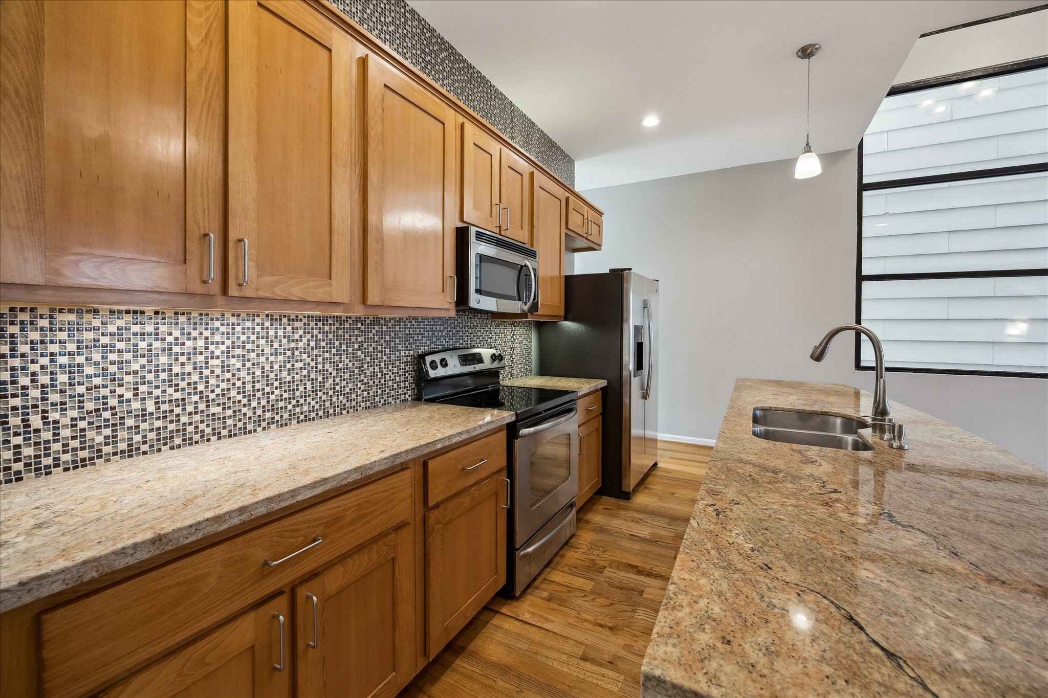 802 Waverly Street, Unit D Houston, TX 77007 - Photo 8 of 30 a kitchen with stainless steel appliances a sink stove and cabinets