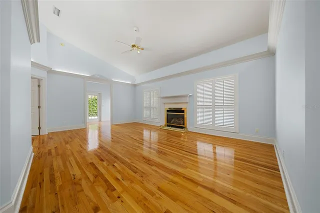 a view of empty room with wooden floor