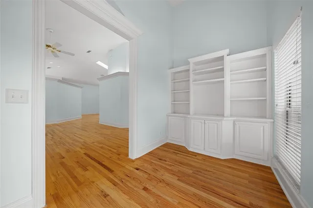a view of empty room with wooden floor