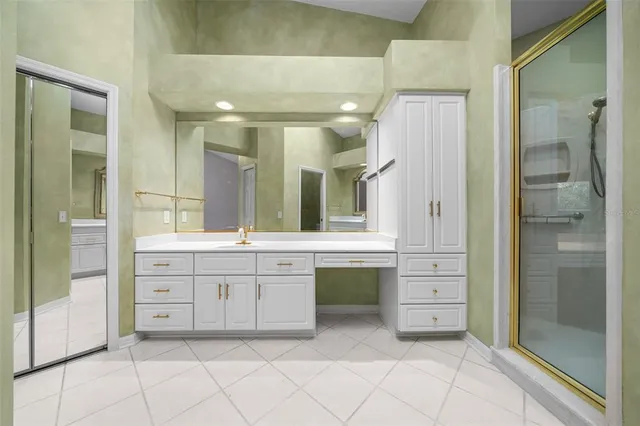 a spacious bathroom with a granite countertop sink mirror and a