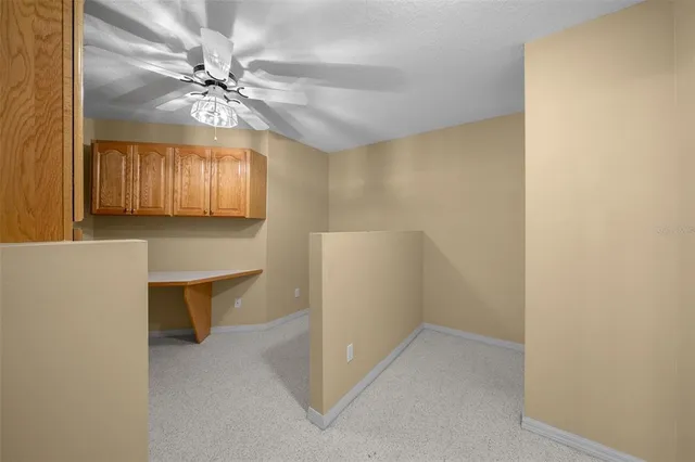 a view of an empty room with a ceiling fan