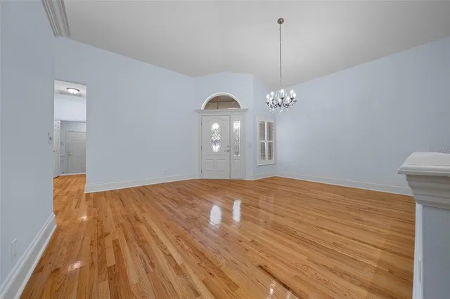 a view of a room with wooden floor and white walls