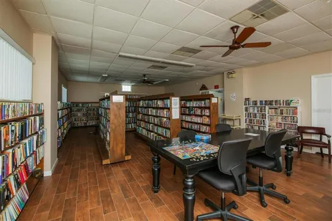 a dining room with furniture and a book shelf