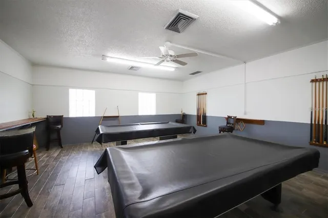 a kitchen with a table chairs a stove a dining table and chairs