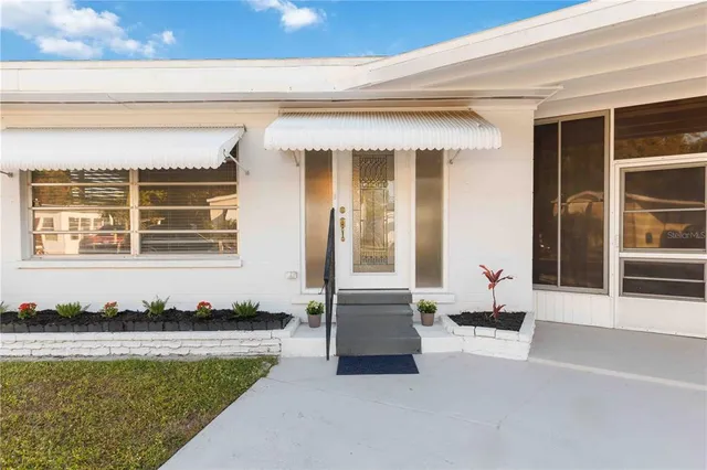 a front view of a house with swimming pool and porch