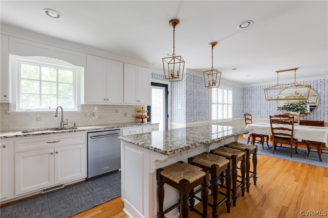 13331 Kingsmill Road Midlothian, VA 23113 - Photo 14 of 49 a kitchen with stainless steel appliances granite countertop a stove top oven a sink dishwasher a dining table and chairs with wooden floor