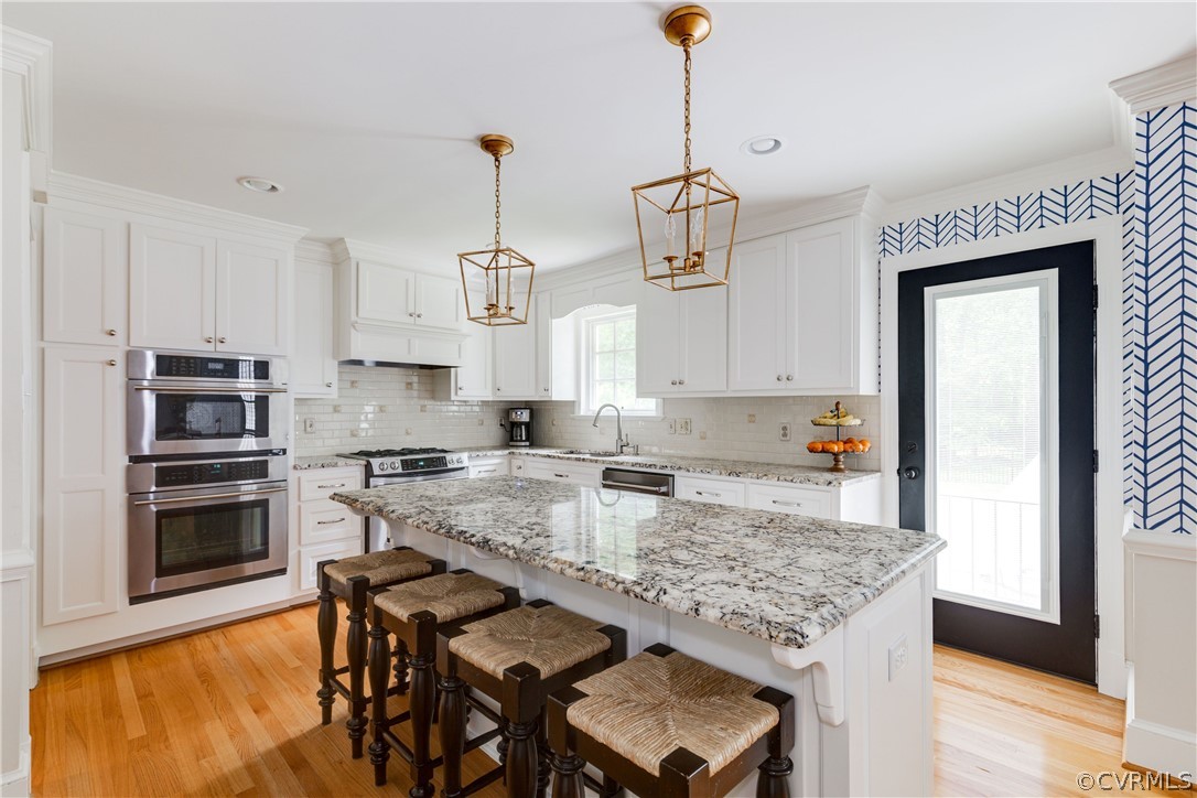 13331 Kingsmill Road Midlothian, VA 23113 - Photo 15 of 49 a kitchen with stainless steel appliances granite countertop a stove top oven a sink a counter space and cabinets