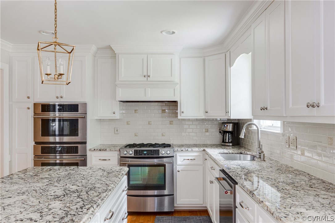 13331 Kingsmill Road Midlothian, VA 23113 - Photo 19 of 49 a kitchen with stainless steel appliances granite countertop a stove a sink and a refrigerator