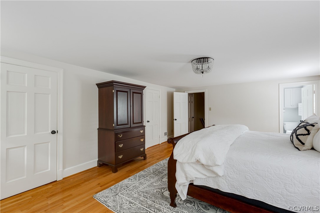 13331 Kingsmill Road Midlothian, VA 23113 - Photo 29 of 49 a bedroom with a bed and wooden floor