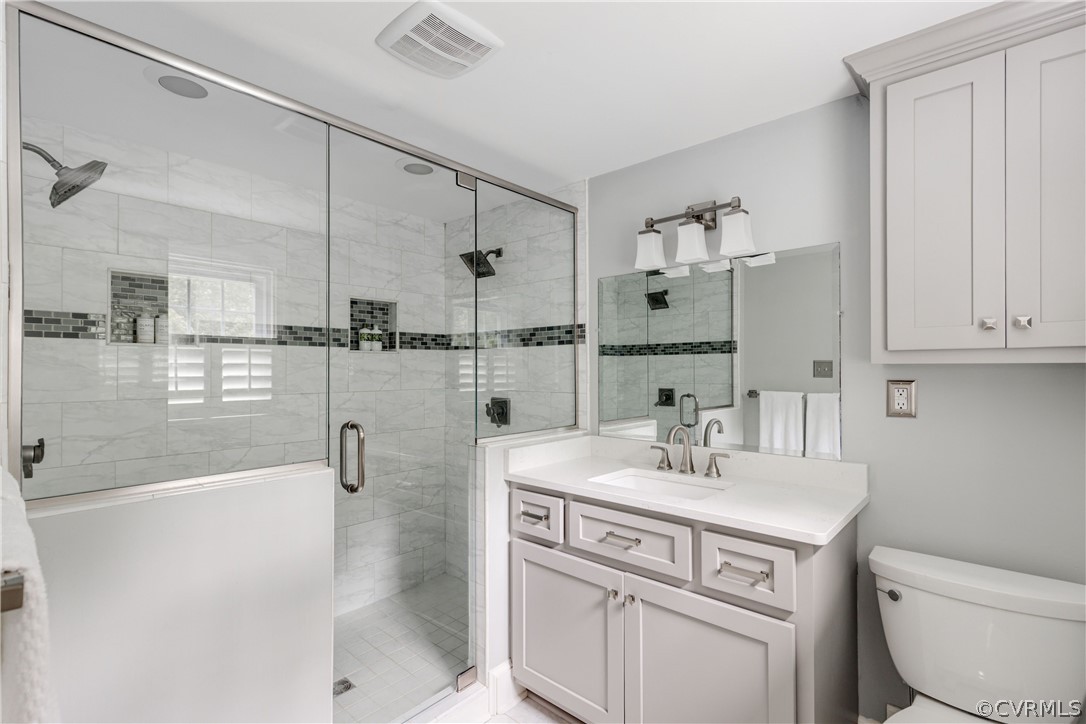 13331 Kingsmill Road Midlothian, VA 23113 - Photo 30 of 49 a bathroom with a sink toilet double vanity and tub
