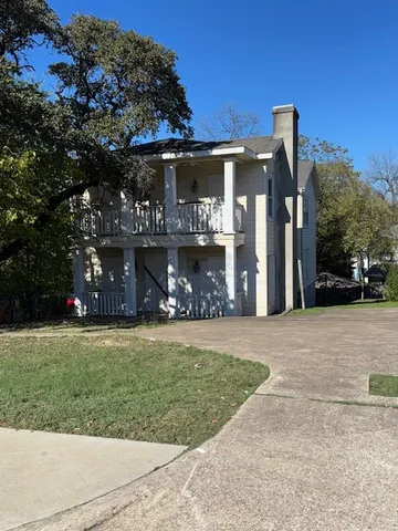 a view of a house with a yard and garage