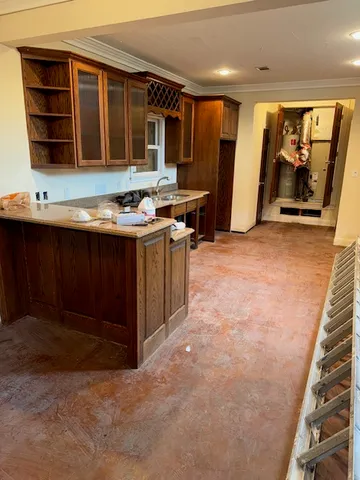 a view of kitchen with stainless steel appliances granite countertop a stove and a sink
