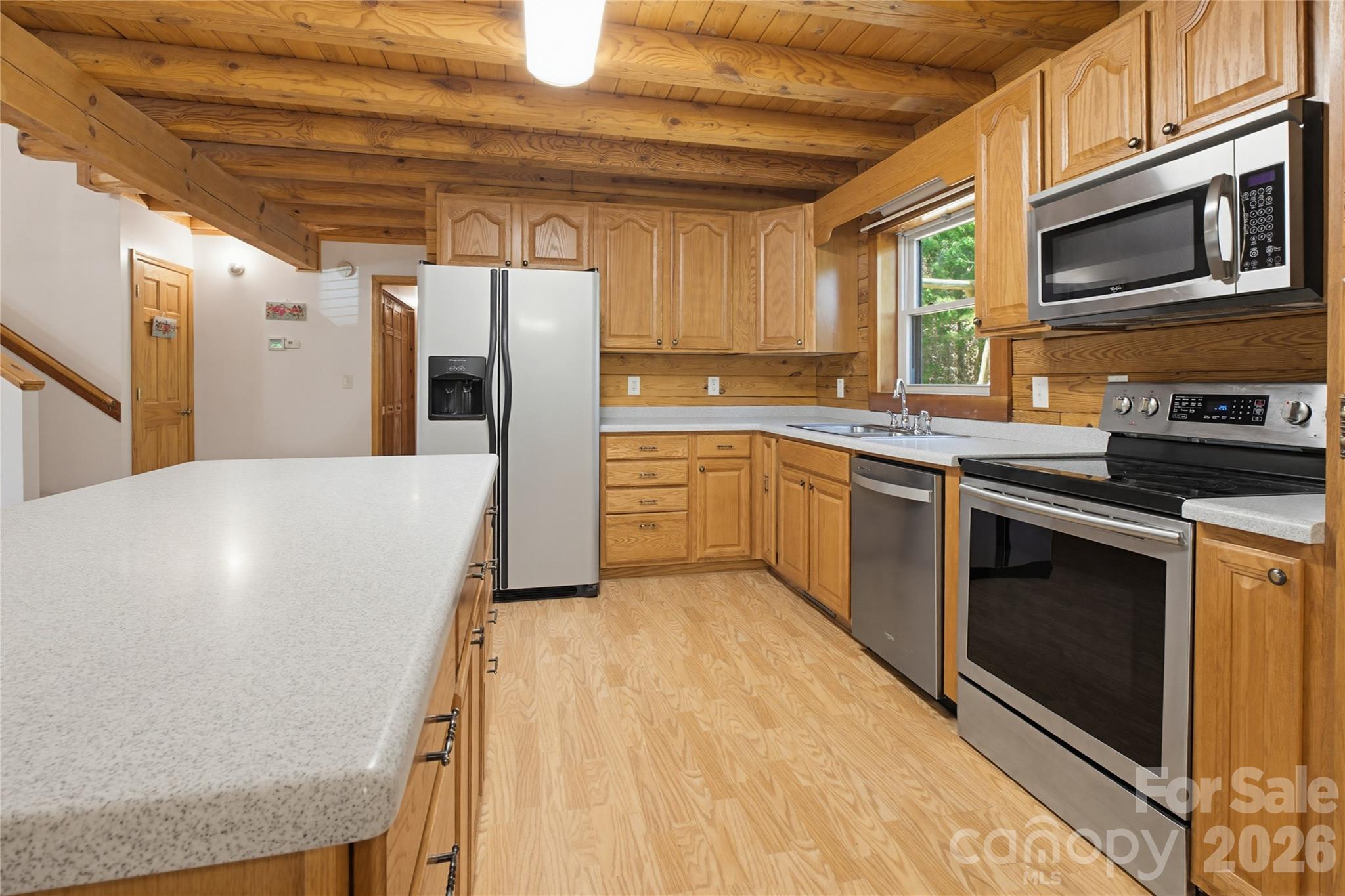451 Rustic Ridge Drive Canton, NC 28716 - Photo 11 of 44 a kitchen with stainless steel appliances a stove a sink a microwave and cabinets